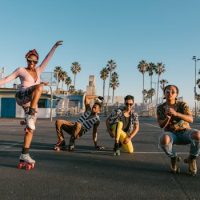 A lively group enjoying roller skating under the sun at Venice Beach