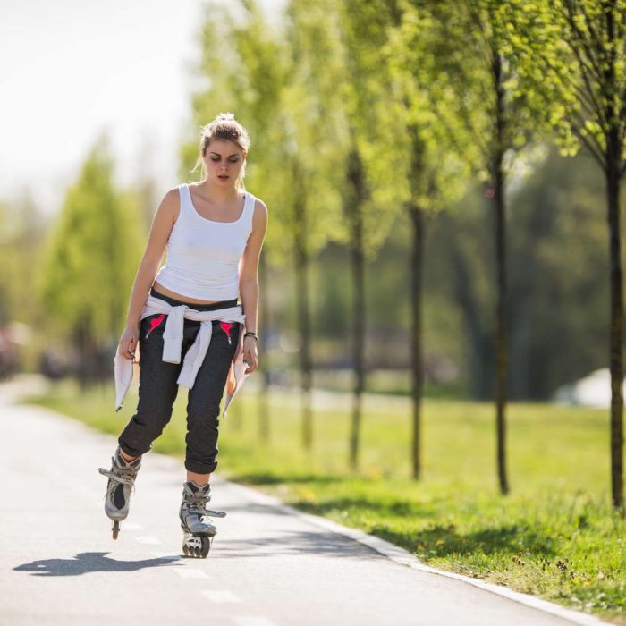 young-woman-roller-skating-during-spring-day-in-the-park--485376022-5a82864ba18d9e0036eabeb0